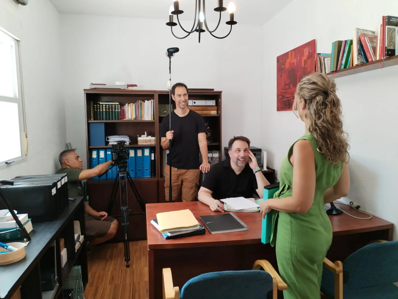 Actors and film crew behind the scenes of an office scene